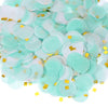 A pile of round tissue paper confetti dots in light mint green and white with gold accents.