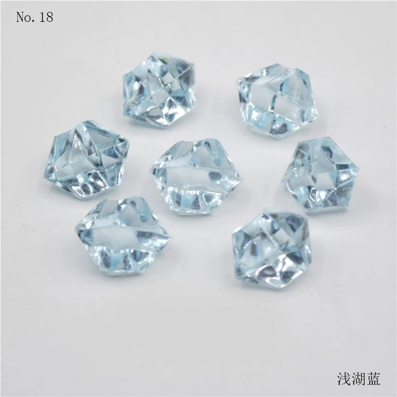 A collection of clear, faceted crystal ice cubes or acrylic stones for decorative use.