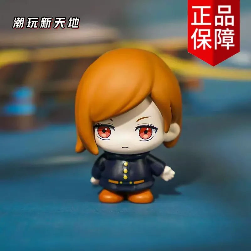 A collectible figure of Gojo and Geto from Jujutsu Kaisen, featuring orange hair and dark clothing.
