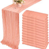 A set of ten terracotta semi-sheer cheesecloth table runners in a dusty rose color.