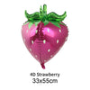 A glossy pink 4D strawberry balloon with green leaves and a pink stem.