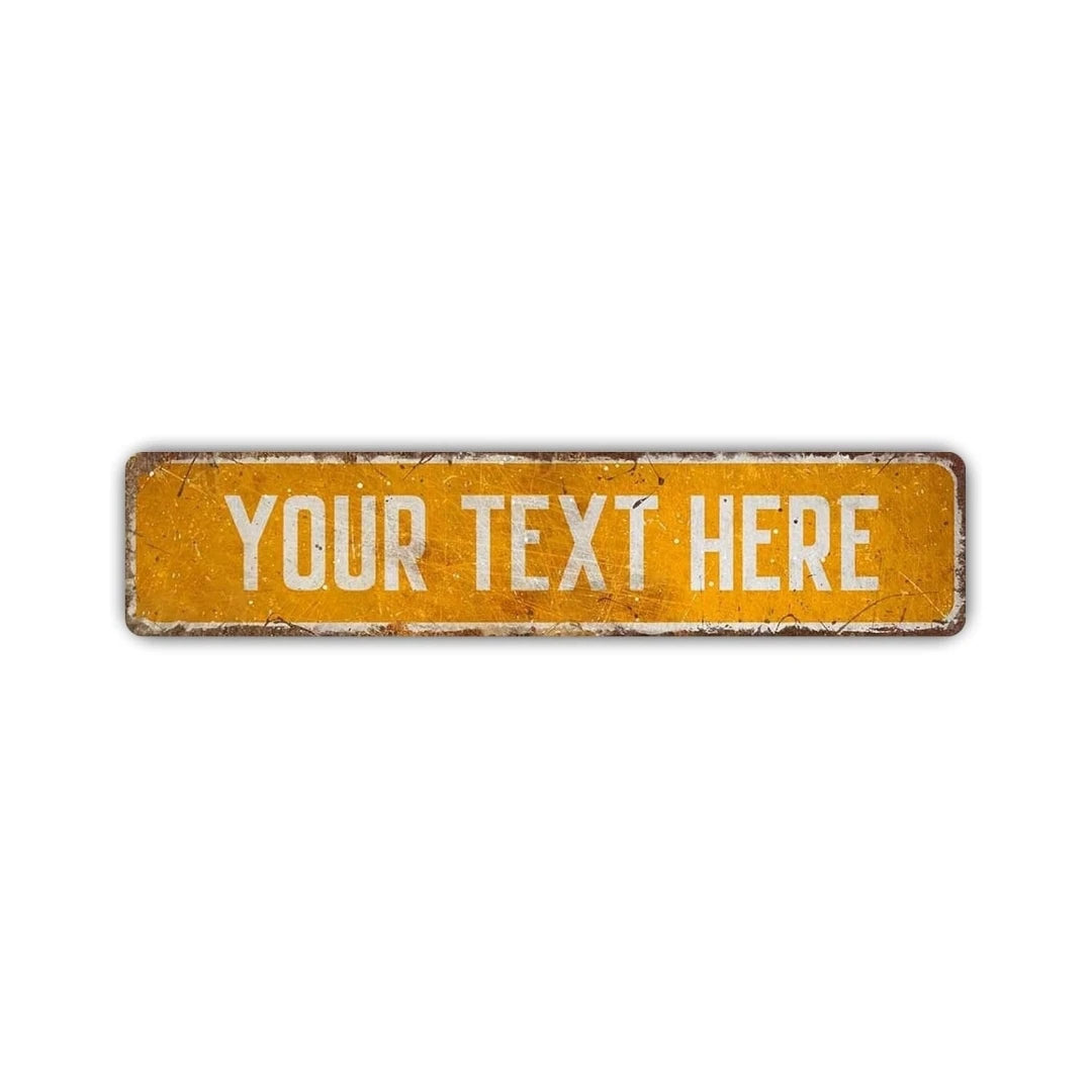 A rectangular, weathered yellow aluminum street sign with the text YOUR TEXT HERE stamped on it.