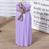 A purple plastic vase with a woven rope tied around the neck, displayed next to text.