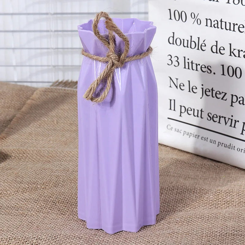 A purple plastic vase with a woven rope tied around the neck, displayed next to text.