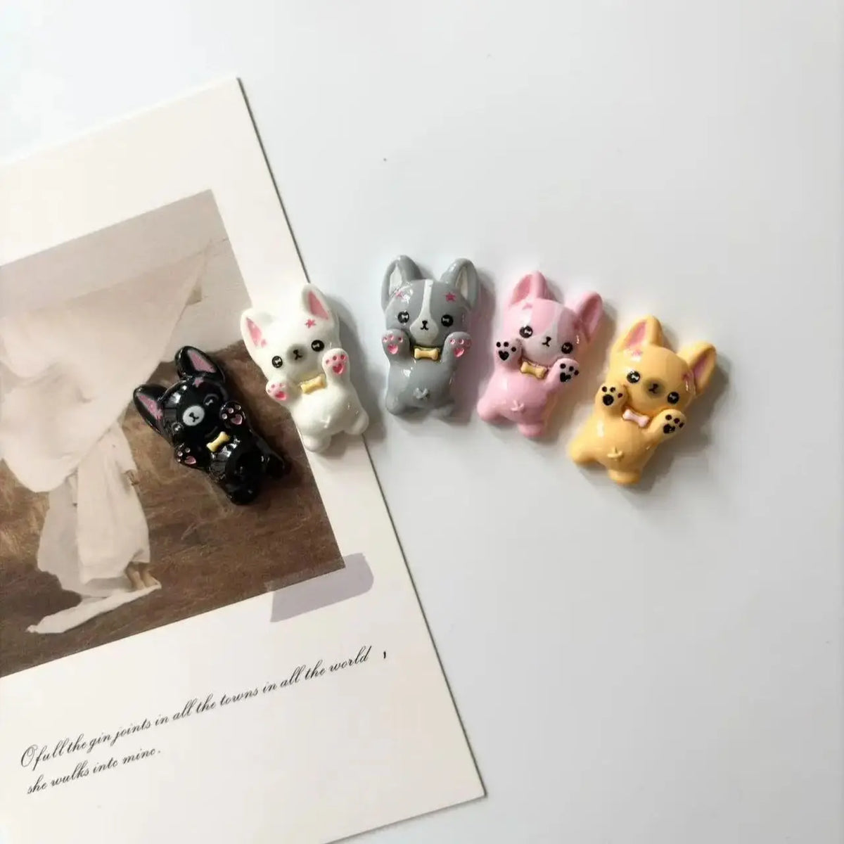 A set of mini puppy refrigerator magnets in various pastel colors and shades