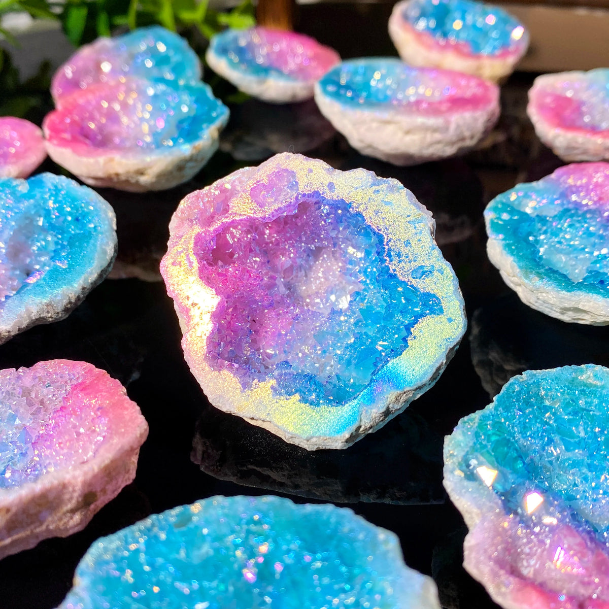 Iridescent blue and pink agate crystal geode stone with sparkling inclusions