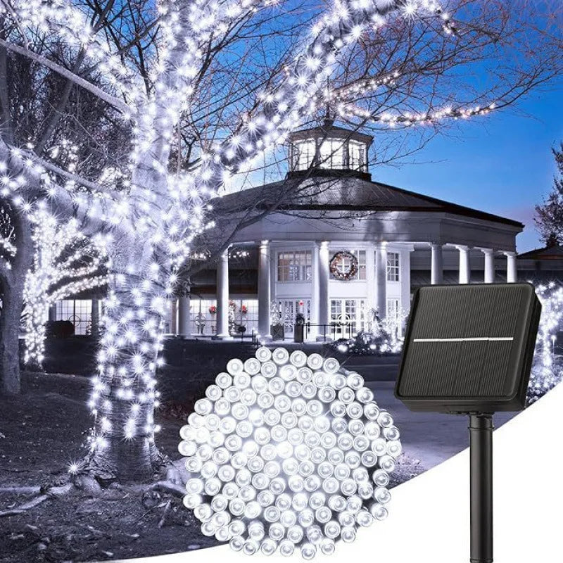 A black solar-powered outdoor light fixture with a spherical arrangement of bright white fairy lights illuminating a classica