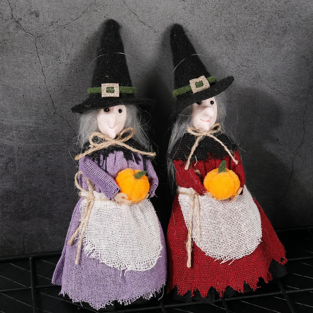 A pair of witch ornaments featuring a purple and white dress with orange pumpkins.