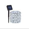 A bundle of clear fairy lights is shown next to a small solar panel.
