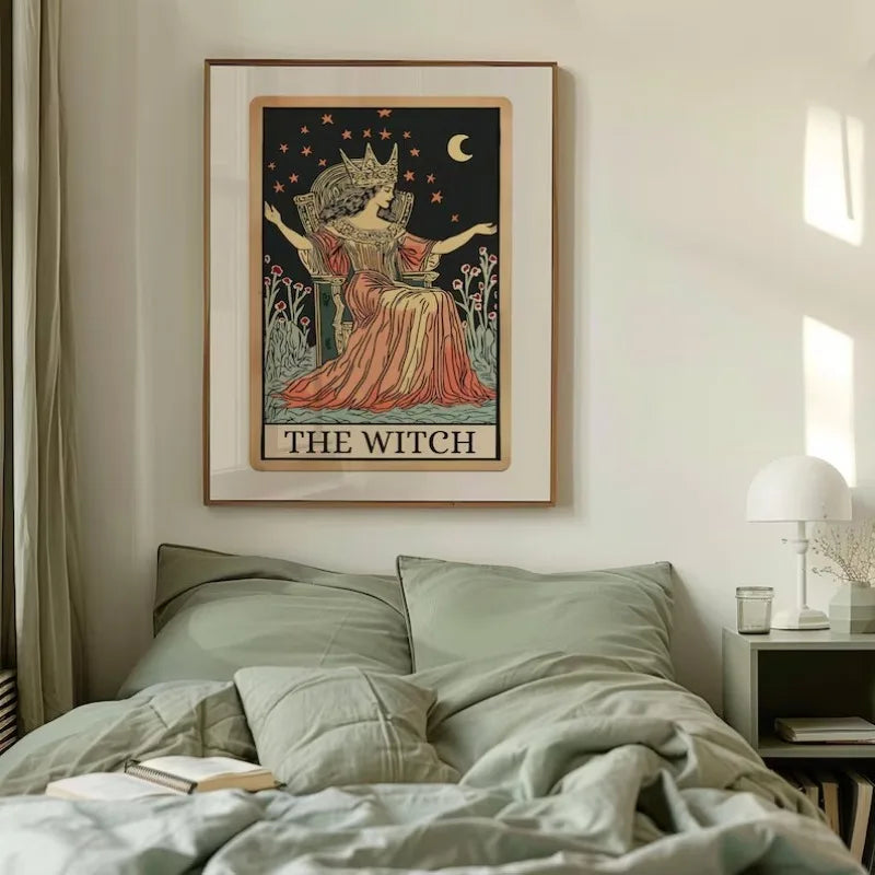 A framed poster depicting a witch figure with a crown and crescent moon on a light background.