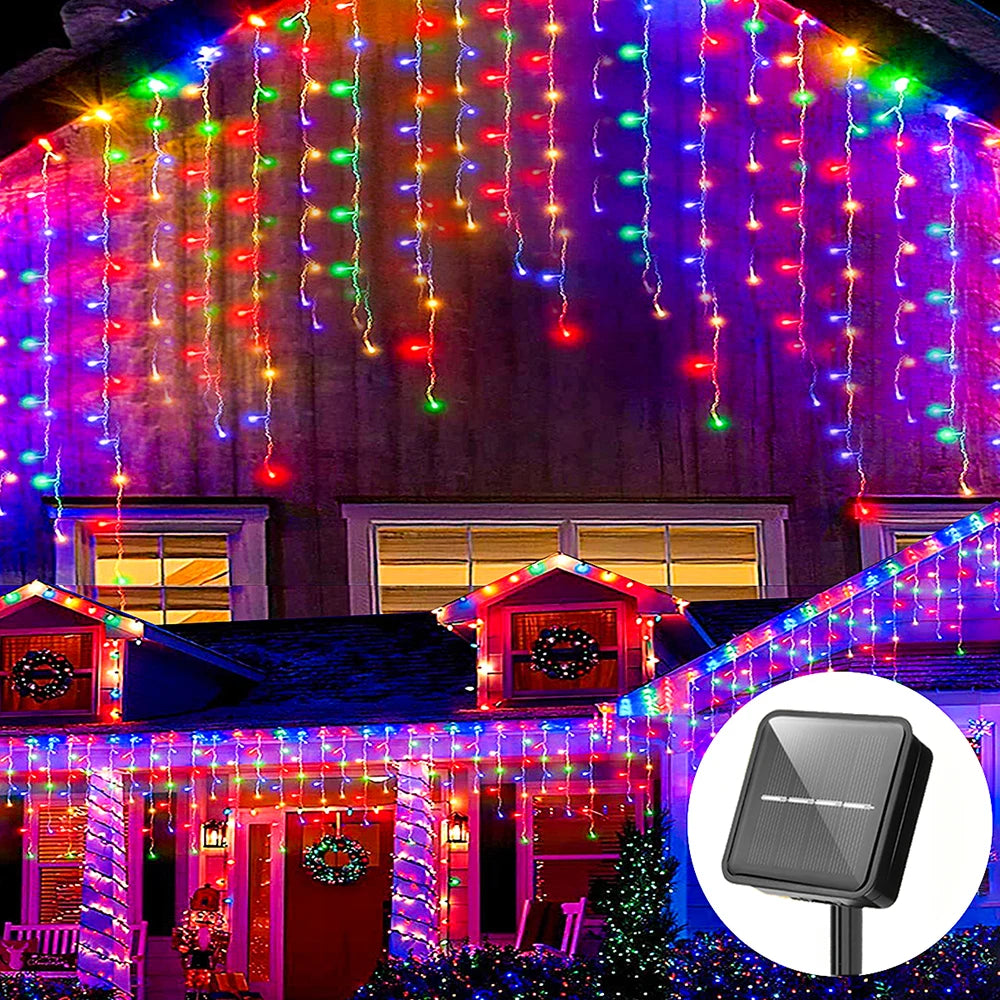 String lights decorate a house facade and roofline with colorful LED icicle lights.