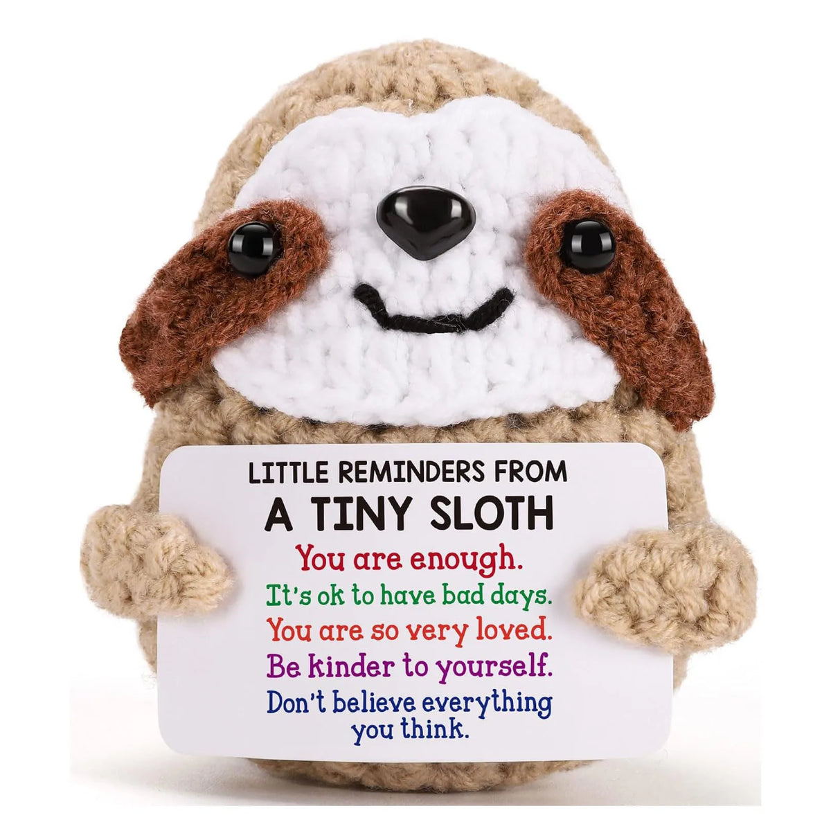 A handmade crochet emotional support donkey desktop ornament with brown and white fur and black features.