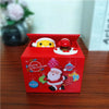 A red box for an interactive coin bank with animal designs, featuring a yellow and red animal figure and Santa Claus.