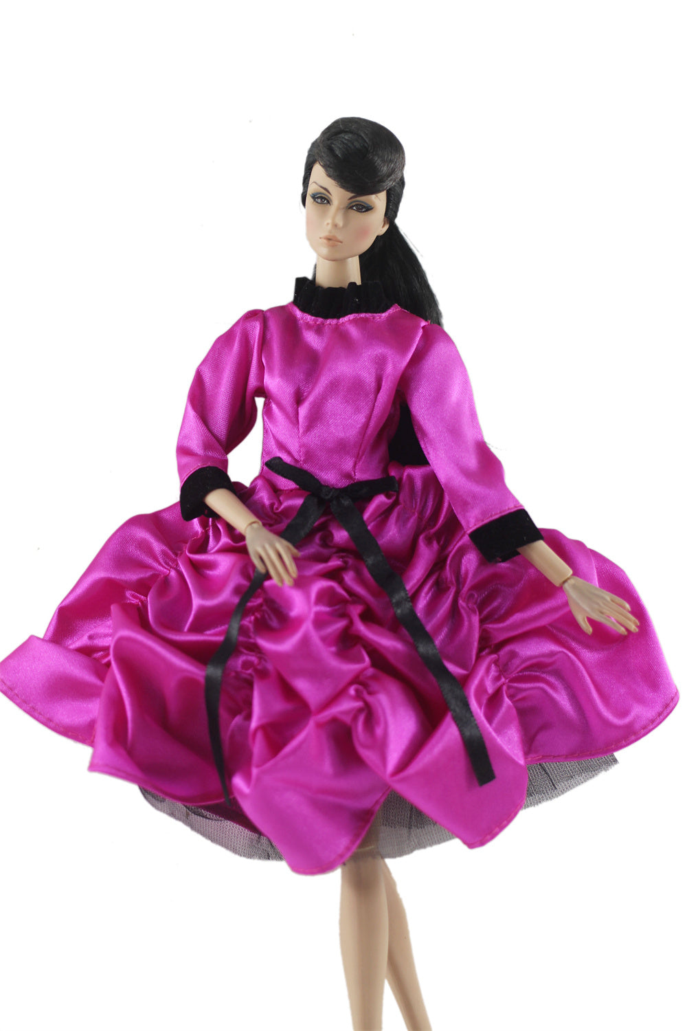A handmade doll dress gown in vibrant pink satin with black accents and a black collar.