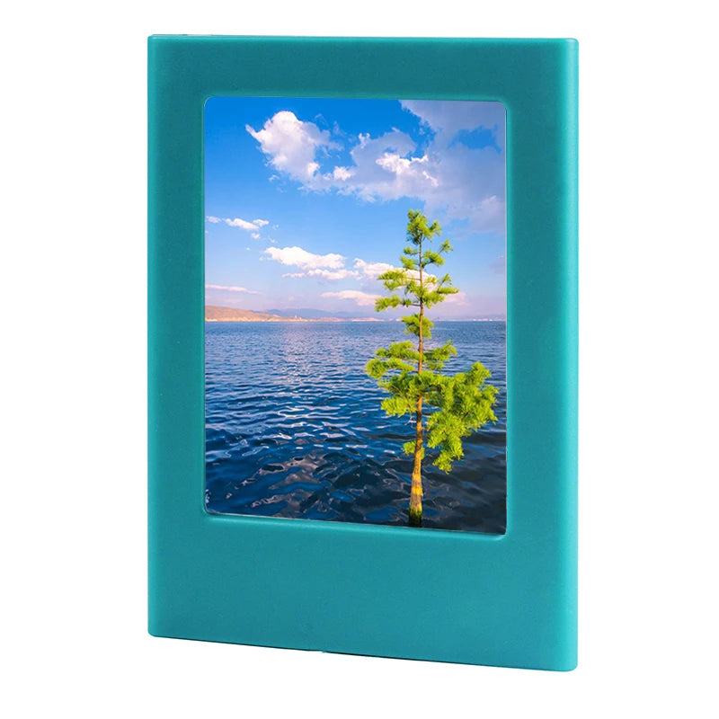 A teal magnetic double-sided frame displaying a scenic view of the ocean and sky with clouds.