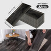 A package of dark gray wood grain peel-and-stick flooring and wall stickers, showing a sample piece and installation on a woo