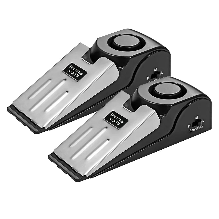 A pair of black door stop security alarms with silver plates and sensitivity settings.