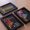 Three framed pieces of art showing cityscapes and fireworks created with scratch painting techniques.
