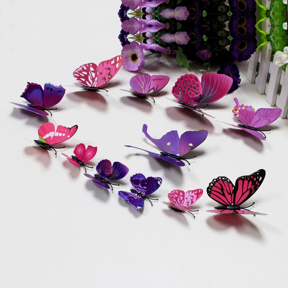 A collection of twelve colorful 3D butterfly wall decor stickers in shades of pink, purple, and magenta arranged on a white s