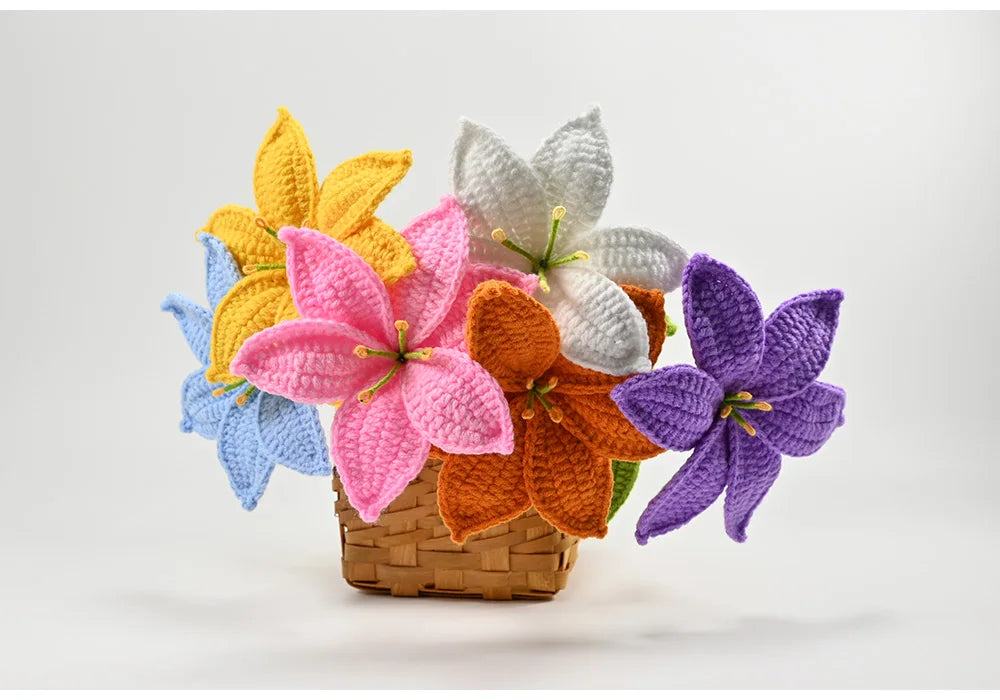A hand-crocheted bouquet of colorful artificial lily flowers in shades of yellow, pink, purple, and white, displayed in a wov