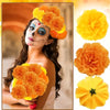 A woman wearing face paint and a flower crown, holding artificial orange and yellow carnation and marigold flower heads for f