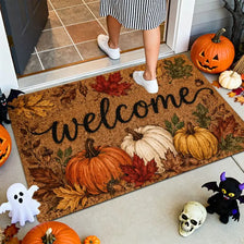 A vintage harvest pumpkin maple leaf doormat featuring pumpkins, leaves, and a welcome message on a light-colored entryway ru