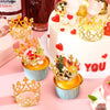A display of mini gold and silver crown cake toppers and decorations on a pink platter.