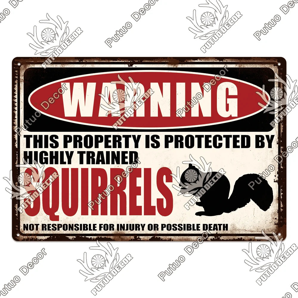 A vintage metal warning sign with red lettering that reads Warning This property is protected by highly trained squirrels.