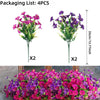 Two sets of artificial outdoor decorative flowers in vibrant purple and pink colors displayed in a wooden planter.