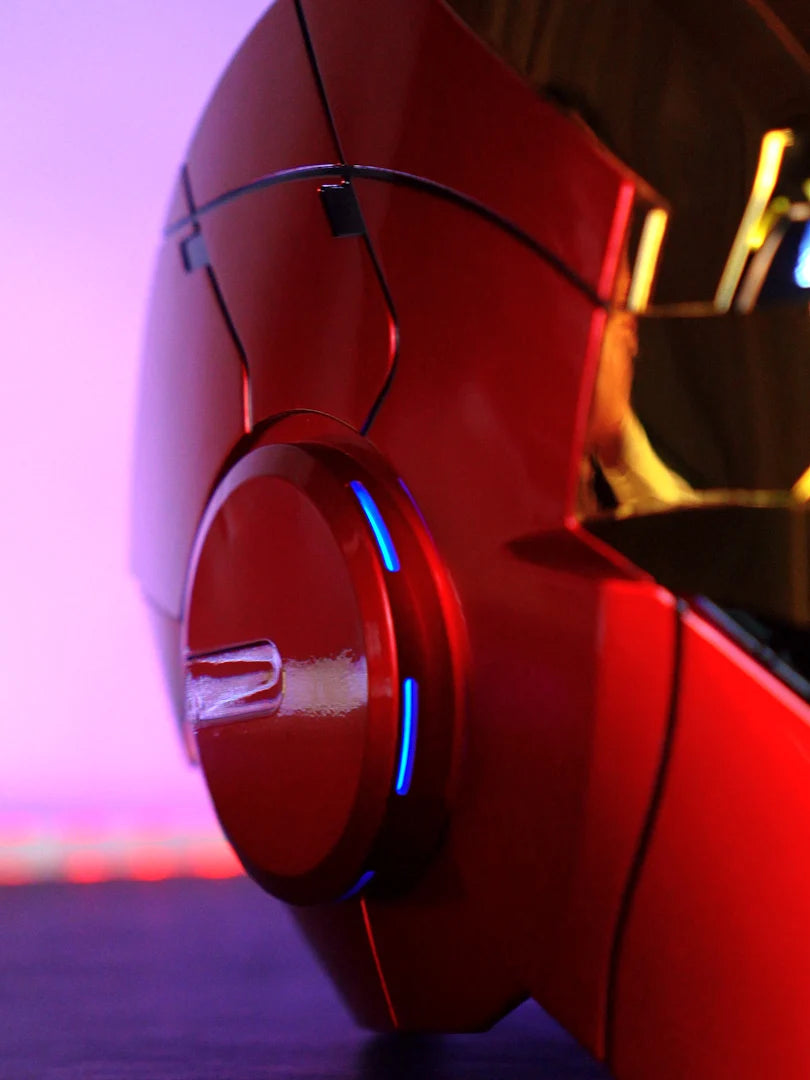 Close-up of a red Iron Man MK5 wearable helmet with blue LED lights and a circular control button.