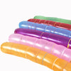 A stack of colorful latex rocket balloons in shades of green, red, blue, purple, and orange.