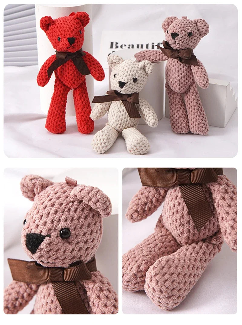 Three crocheted teddy bears in red, beige, and pink with brown bows displayed on a white background.