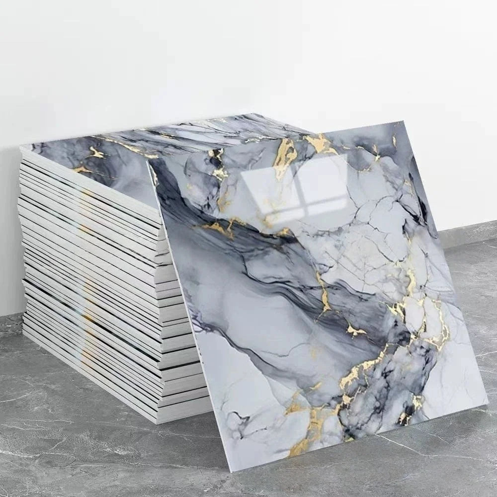 A sheet of self-adhesive marble tile stickers featuring gray and black marble patterns with gold veining.