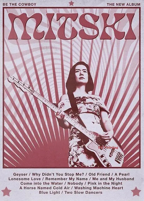 Album cover art for Mitski's new album Be The Cowboy featuring a woman playing an electric guitar.