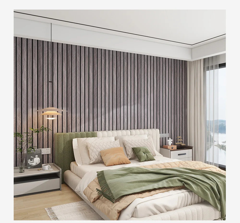A bedroom featuring a bed with light green bedding and a textured wood-grain wallpaper accent wall.