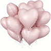 A cluster of ten pink heart-shaped foil balloons tied together for a celebration.