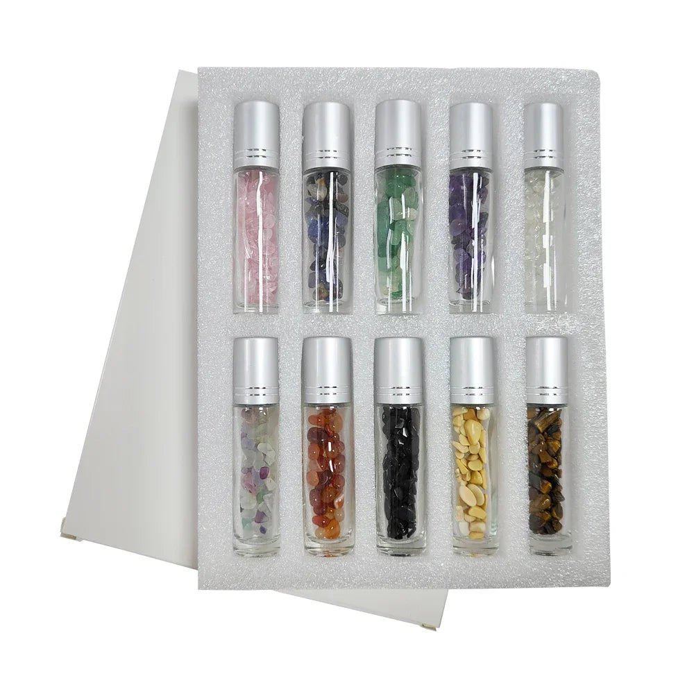 A set of ten refillable roll-on bottles containing various colored semi-precious stone roller balls arranged in a foam tray.
