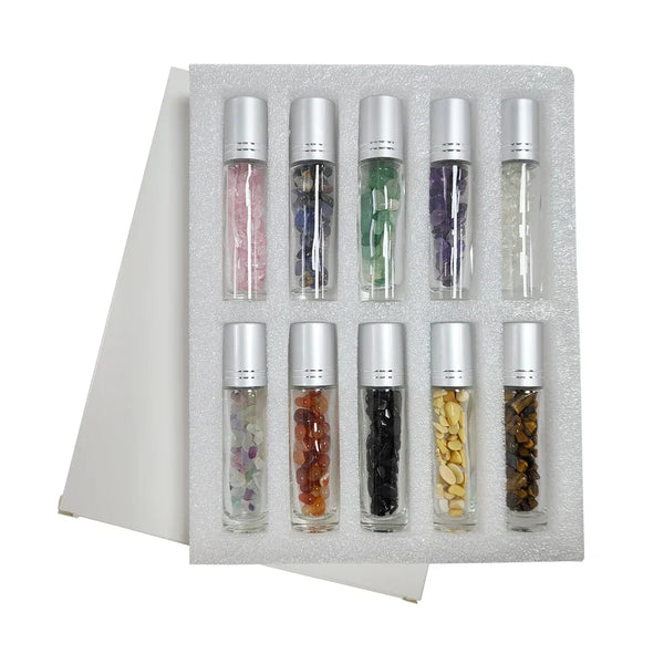 A set of ten refillable roll-on bottles containing various colored semi-precious stone roller balls arranged in a foam tray.