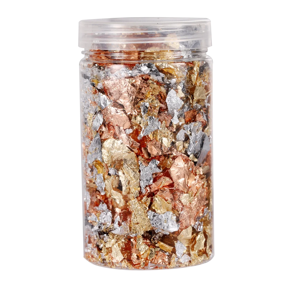 A clear jar filled with shiny gold foil flakes for resin art and jewelry making