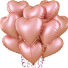 A cluster of pink heart-shaped foil balloons tied together with ribbons.