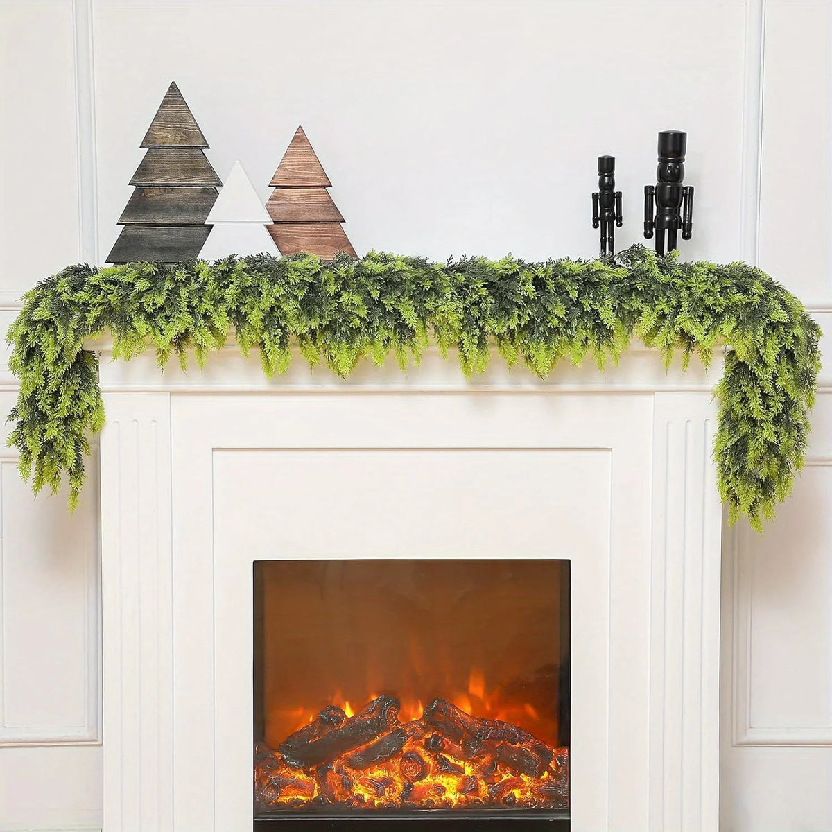 Extra long pine vine wreath for holiday decor displayed on a white fireplace mantel