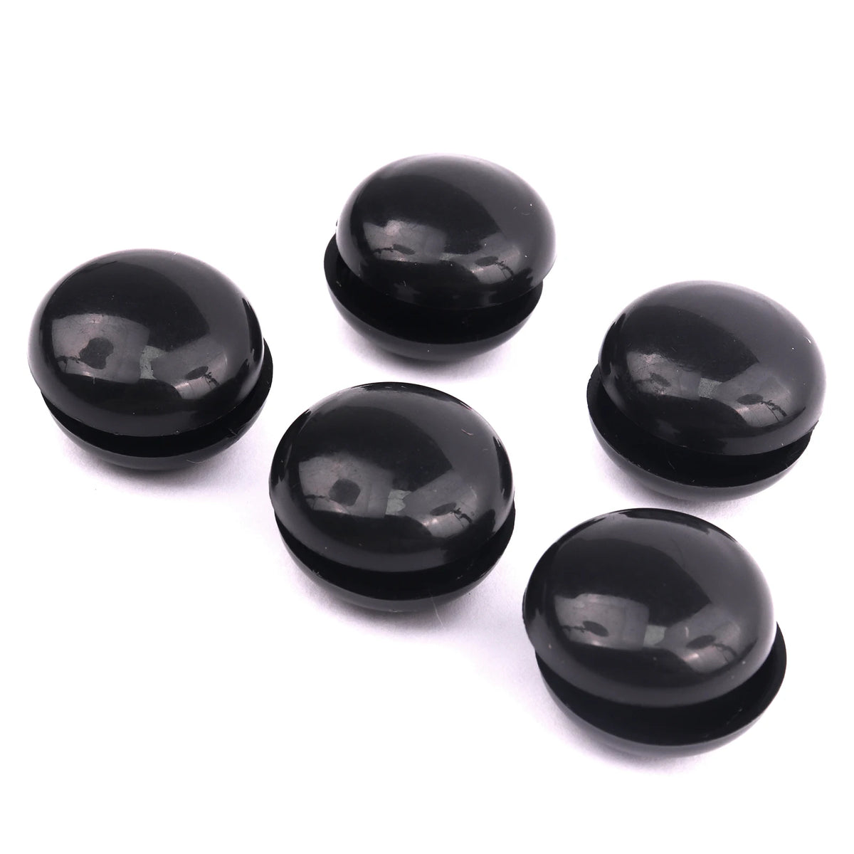 A set of ten black refrigerator magnets, round and glossy, arranged on a white background.