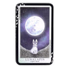 A black metal tin holding a Lunalapin tarot deck featuring a full moon and a rabbit.