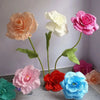A collection of silk foam roses in various shades of pink, peach, white, and blue displayed on green stems.