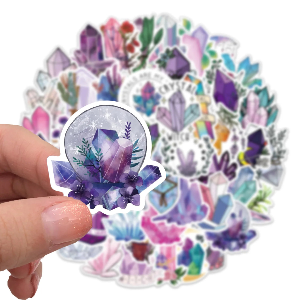 A hand holds a circular arrangement of colorful crystal and floral decorative stickers.