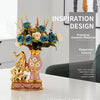 A floral arrangement featuring blue and peach flowers displayed alongside a golden elephant ceramic vase.