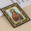 A framed religious icon depicting Jesus Christ with a halo and St. Michael, set in a black frame with gold accents.