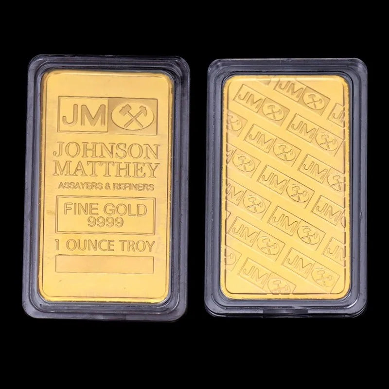 Two rectangular gold bullion ingots labeled Johnson Matthey Fine Gold 9999 1 ounce Troy