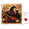 Diamond painting wall decor featuring a black witch hat, cat, crescent moon, and autumn foliage on a beige background.