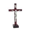 Handcrafted wooden crucifix with a corpus mounted on a stand